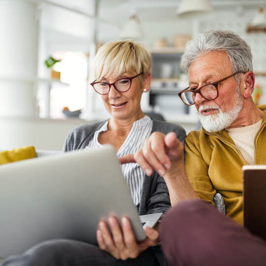 Happy romantic senior couple hugging and enjoying retirement at home
