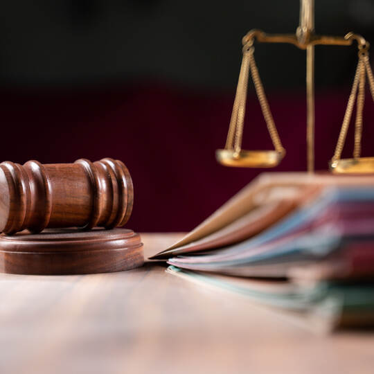 focus on hammer, group of files on judge table covered with dust - concept of pending old cases or work at judicial court