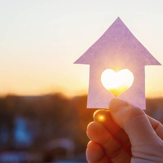 House with a carved heart on of sunrise.