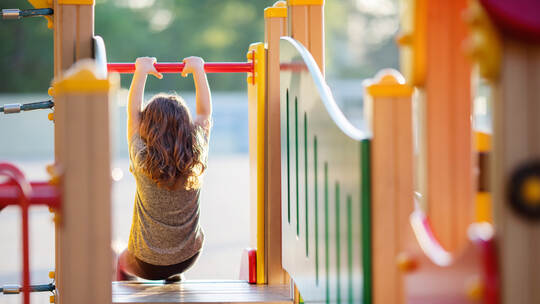 Little kid on playground, children's slide
