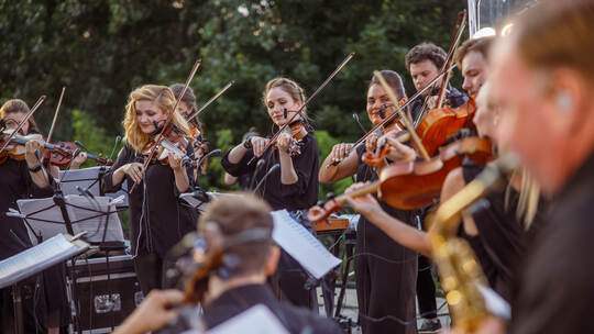 Violin players playing classic instrumental music on the street