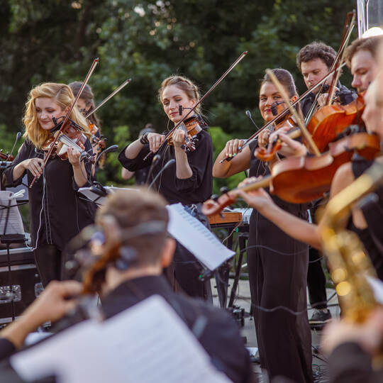Violin players playing classic instrumental music on the street