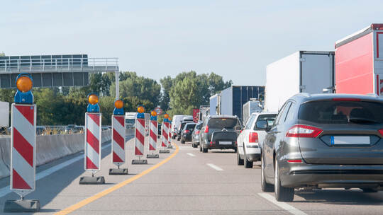 freeway with building lot and traffic jam