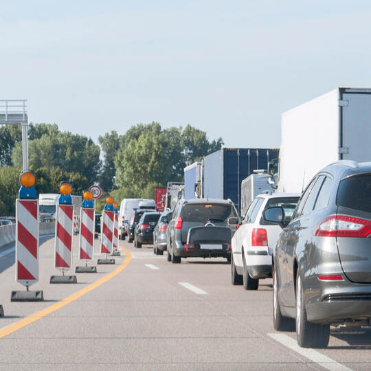 freeway with building lot and traffic jam