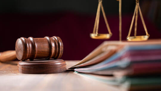 focus on hammer, group of files on judge table covered with dust - concept of pending old cases or work at judicial court