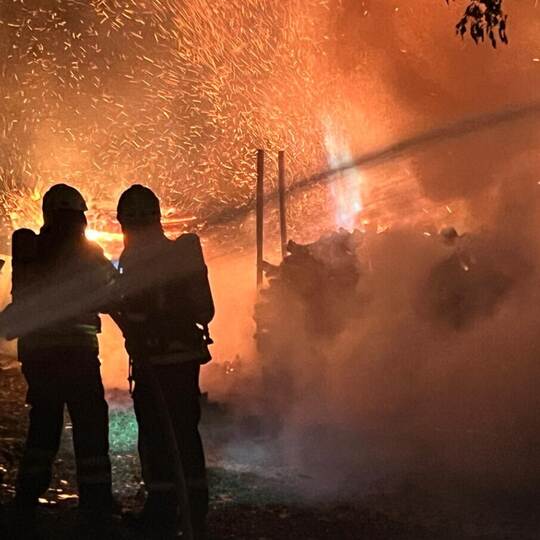 Fireman extinguish fire with the hose. Burning house fire drill