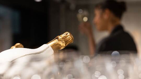 Eine Champagner-Flasche liegt in einem Kühler.