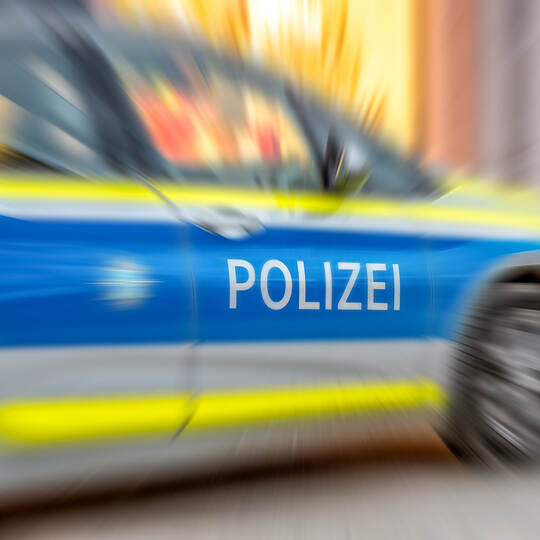 Motion blur of German police car with letters POLIZEI.