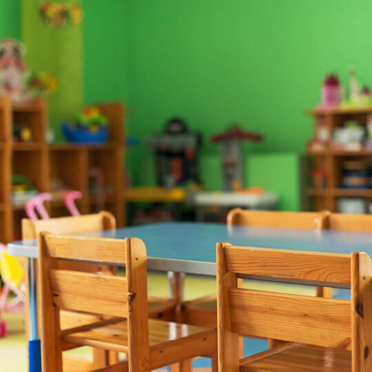 Chairs, table and toys. Interior of kindergarten.