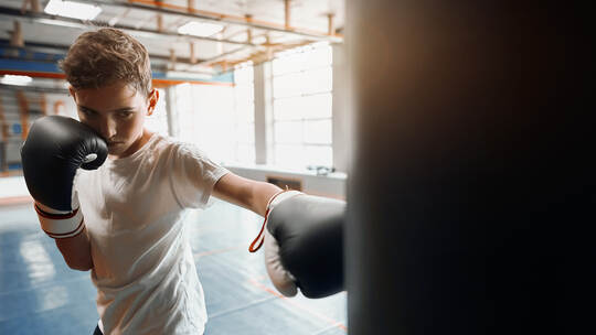 agressive angry boy is good at kickboxing