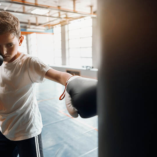 agressive angry boy is good at kickboxing