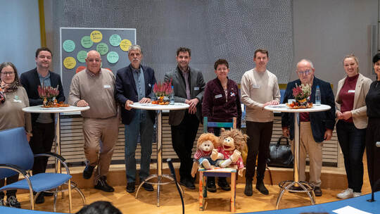 Mit dem Stuhl und den Handpuppen „Ilselotte“ und „Max“ in der Mitte symbolisch Platz für Kinderrechte schaffen möchten (von link