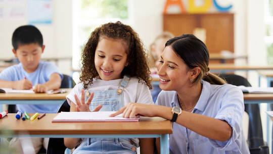 Learning to share is one of the skills we learn at preschool. Shot of a female teacher assisting a preschool learner in her clas