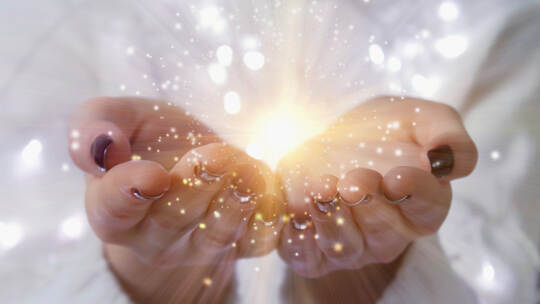 magic particles on the palms of a woman, the flow of magical energy emanating from female hands.