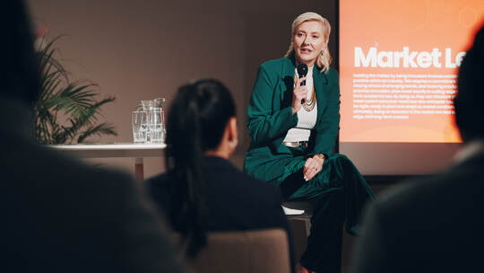 Mature woman, stage and seminar with microphone for leadership skills, information or knowledge. Female person, public speaker a