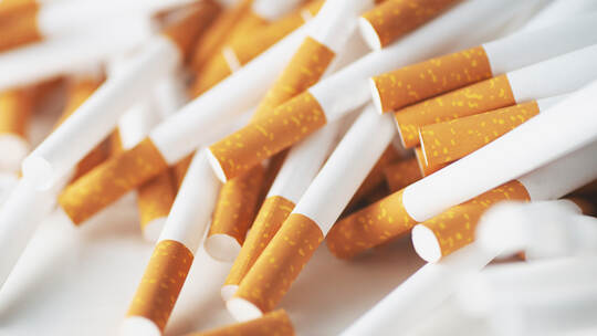 Close up of a smoking cigarettes . cigarette filter tubes