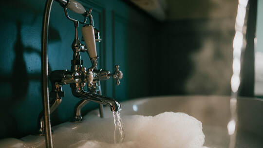 Close-up of vintage tub with flowing water and bubbles