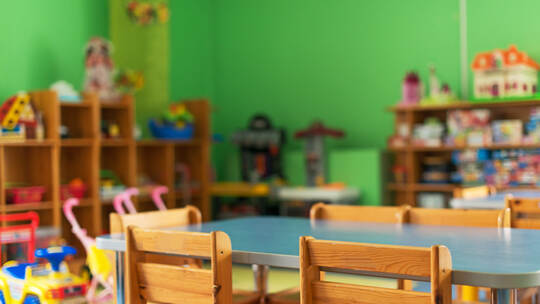 Chairs, table and toys. Interior of kindergarten.