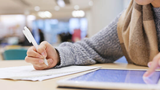 Student taking note on paper