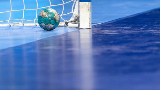 Gate and ball for futsal or handball in gym. Detail of gate frame and net. Outdoor football or handball playground. Horizontal s