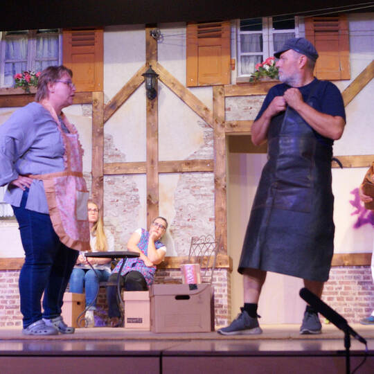 Sattler-Gattin Sofie Moser (Heike Schaier) faltet ihren Leopold (Paul Fischer) – zum Staunen von Cindy Kohler (Laura Hemminger)
