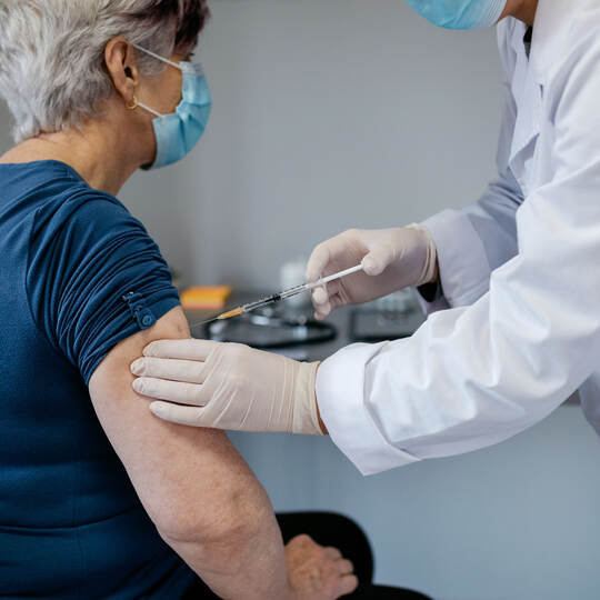 Senior woman being vaccinated against coronavirus