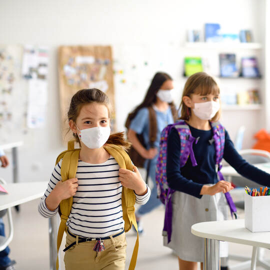 Group of children with face mask back at school after covid-19 quarantine and lockdown.