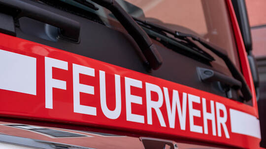 Berlin, Germany - February 09, 2020: The white letters Feuerwehr, the german firefighter logo, on red MAN truck