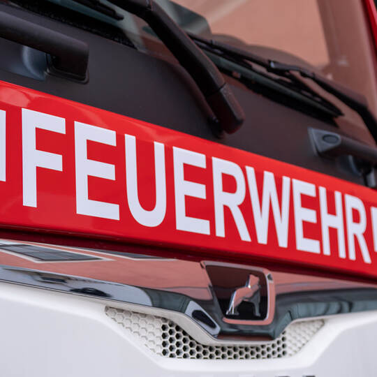 Berlin, Germany - February 09, 2020: The white letters Feuerwehr, the german firefighter logo, on red MAN truck