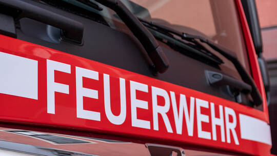 Berlin, Germany - February 09, 2020: The white letters Feuerwehr, the german firefighter logo, on red MAN truck