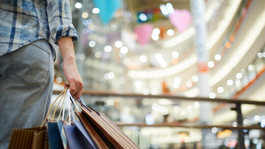 Holding many shopping bags