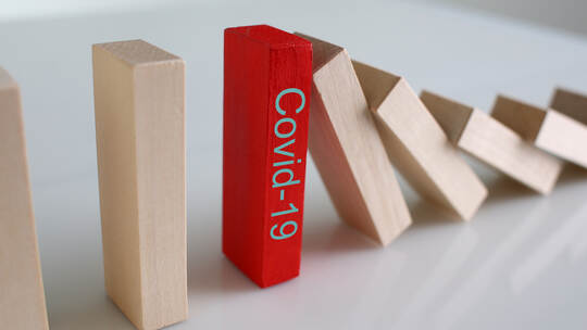Red wooden block with Covid19 sign close-up background