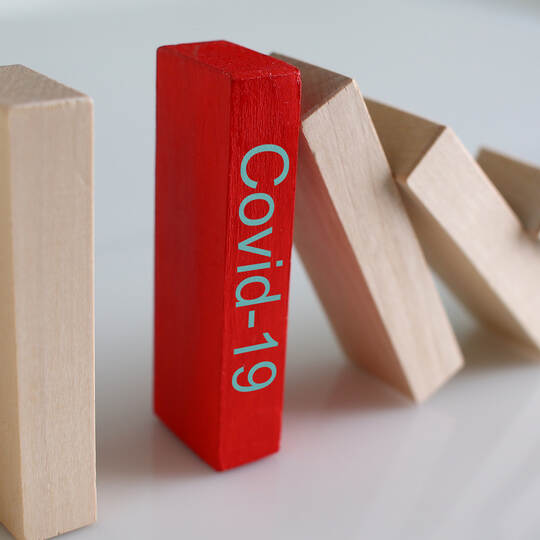 Red wooden block with Covid19 sign close-up background