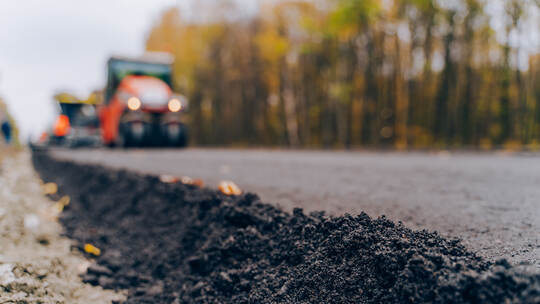 Close view on the new road construction site. Close-up asphalt at the road under construction. Asphalting