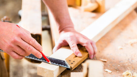 Carpenter with workpiece in carpentry