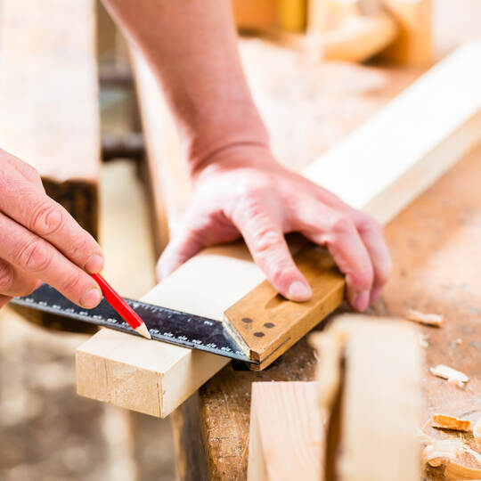 Carpenter with workpiece in carpentry
