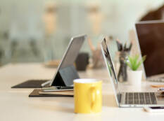 Businesspeople meeting on their project with digital device and office supplies on white desk