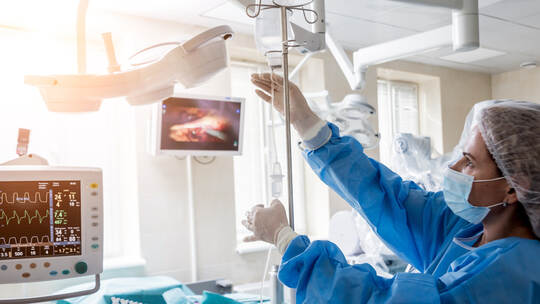 Medical drip tubing and patient at the hospital.