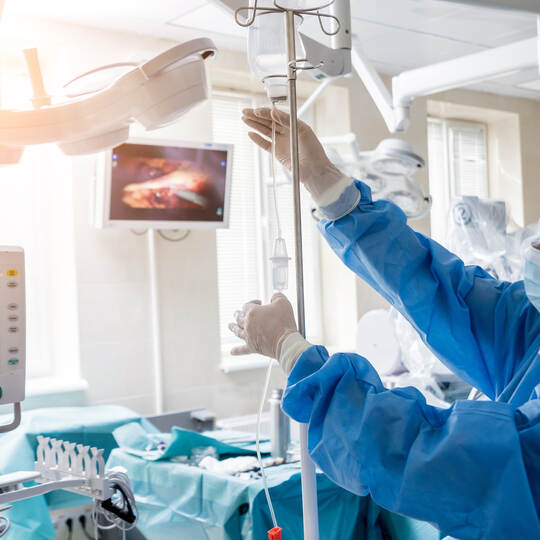 Medical drip tubing and patient at the hospital.