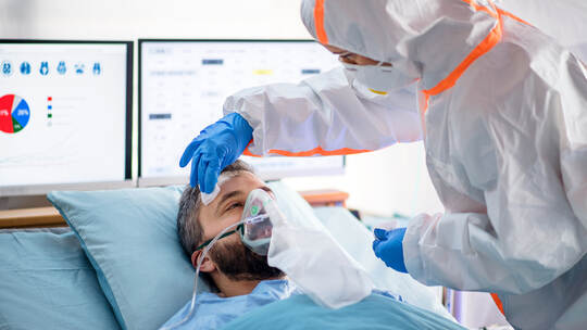 Infected patient in quarantine lying in bed in hospital, coronavirus concept.