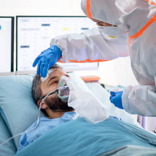 Infected patient in quarantine lying in bed in hospital, coronavirus concept.