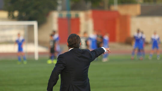 Football coach controlling the game