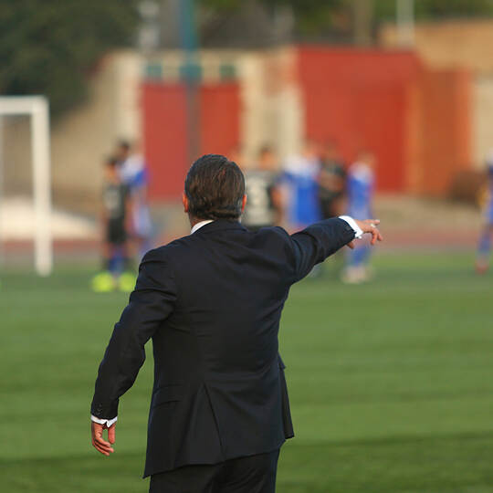 Football coach controlling the game