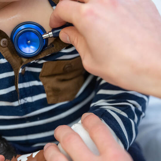 Kinderarzt untersucht Kind