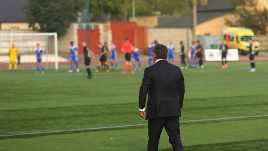 Football coach controlling the game