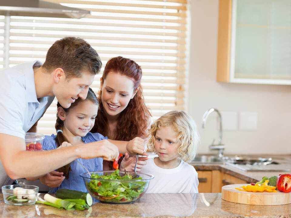 Family preparing salad together
