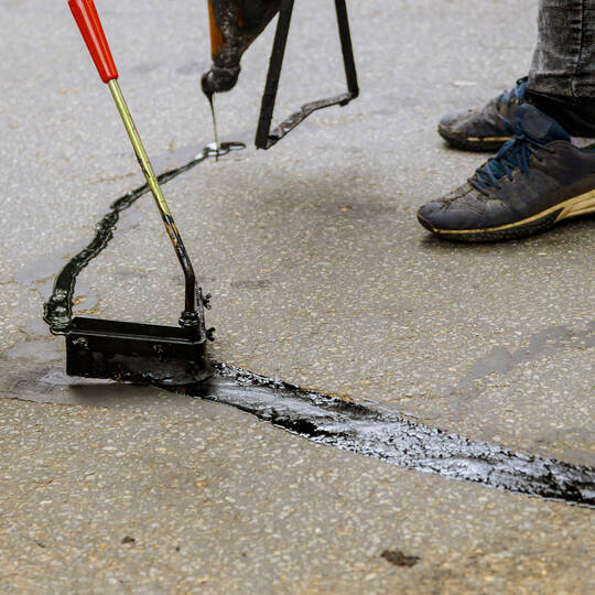 Asphalt road with filled cracks repair, liquid, of the fix road