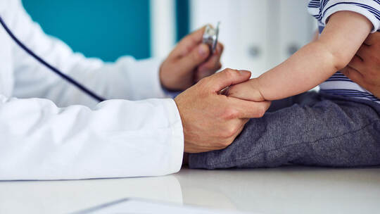 Male doctor examines a child in a medical clinic