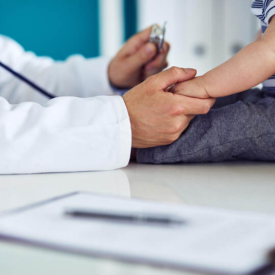 Male doctor examines a child in a medical clinic
