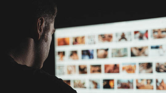 Man browsing porn site late at night.